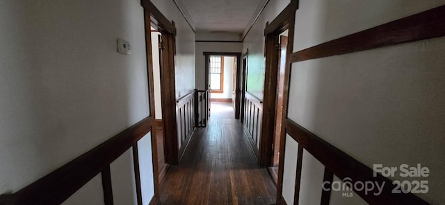 hallway featuring dark wood-style flooring and an upstairs landing