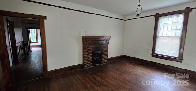 unfurnished living room featuring baseboards, a fireplace, and hardwood / wood-style floors