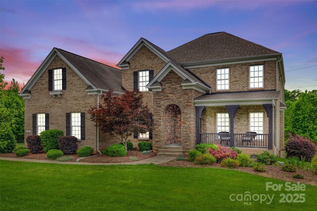 308 Hollister Estates Dr, Waxhaw, NC 28173 - traditional home with a yard, a porch, and a shingled roof