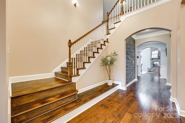 308 Hollister Estates Dr, Waxhaw, NC 28173 - foyer entrance with ornamental molding, wood finished floors, arched walkways, stairway, and baseboards