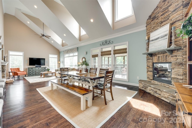 308 Hollister Estates Dr, Waxhaw, NC 28173 - dining space featuring a fireplace, a skylight, high vaulted ceiling, dark wood finished floors, and ceiling fan