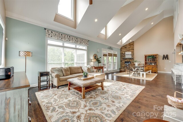 308 Hollister Estates Dr, Waxhaw, NC 28173 - living area with high vaulted ceiling, plenty of natural light, baseboards, crown molding, and wood finished floors