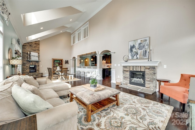 308 Hollister Estates Dr, Waxhaw, NC 28173 - living area featuring a fireplace, wood finished floors, high vaulted ceiling, recessed lighting, and ornate columns