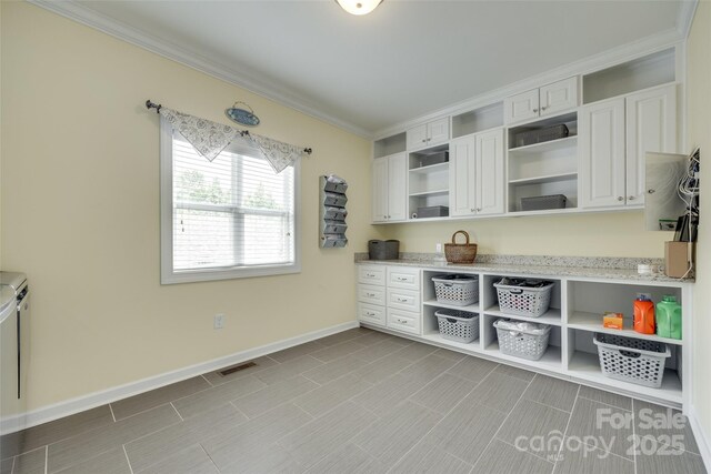 308 Hollister Estates Dr, Waxhaw, NC 28173 - kitchen with open shelves, white cabinets, ornamental molding, light stone counters, and baseboards