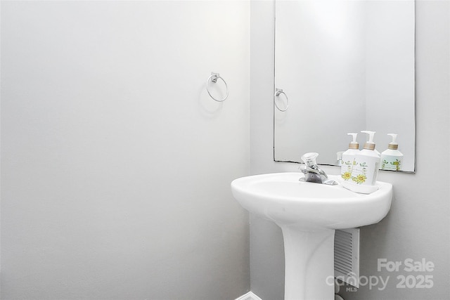 5943 Pisgah Way, Charlotte, NC 28217 - bathroom with baseboards and a sink