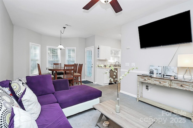5943 Pisgah Way, Charlotte, NC 28217 - living area featuring a healthy amount of sunlight, ceiling fan, visible vents, and light colored carpet