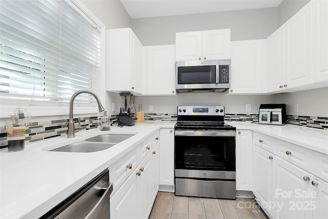5943 Pisgah Way, Charlotte, NC 28217 - kitchen featuring a sink, white cabinetry, backsplash, and stainless steel appliances