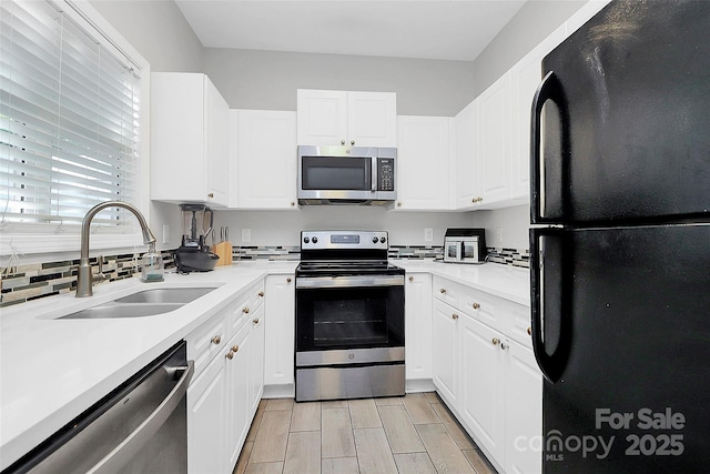 5943 Pisgah Way, Charlotte, NC 28217 - kitchen with a sink, light countertops, stainless steel appliances, and white cabinetry