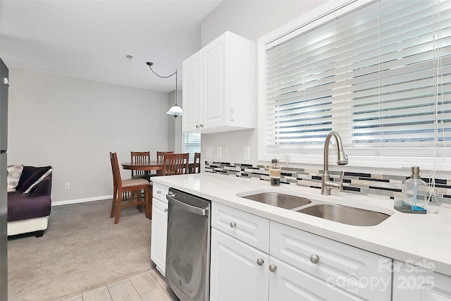 5943 Pisgah Way, Charlotte, NC 28217 - kitchen featuring light colored carpet, stainless steel dishwasher, a sink, light countertops, and white cabinets
