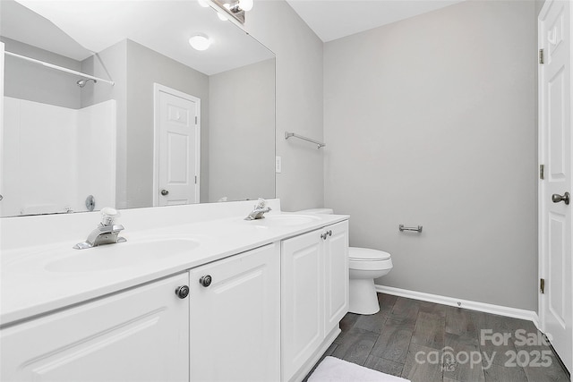 5943 Pisgah Way, Charlotte, NC 28217 - full bath featuring toilet, baseboards, a sink, and wood finished floors
