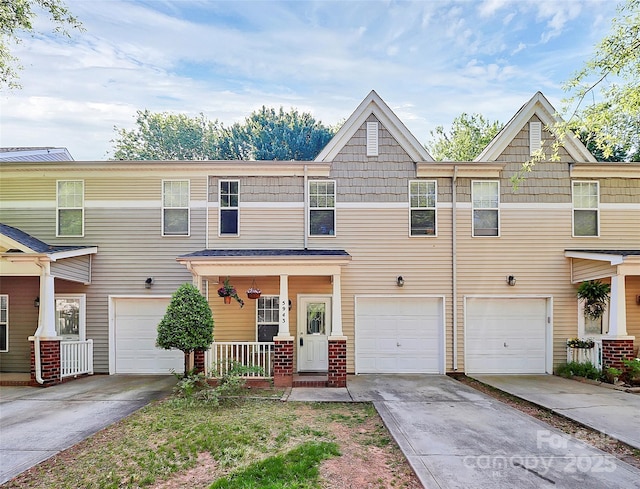 5943 Pisgah Way, Charlotte, NC 28217 - townhome / multi-family property with covered porch, an attached garage, and driveway