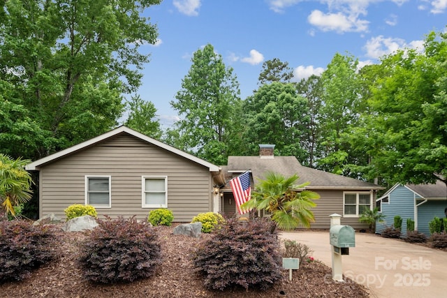 ranch-style home with a chimney