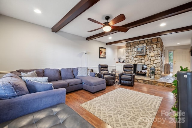 living room featuring beamed ceiling, recessed lighting, ceiling fan, and wood finished floors
