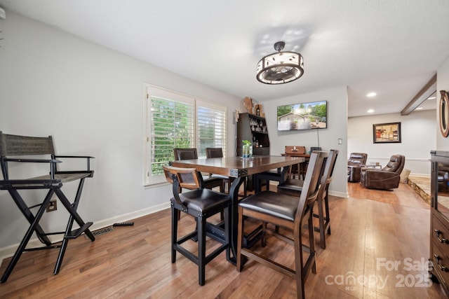 dining room featuring recessed lighting, baseboards, and light wood-type flooring