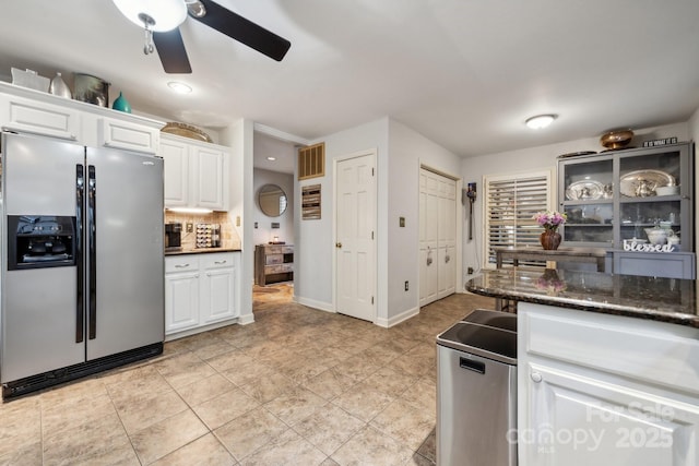 kitchen featuring a ceiling fan, tasteful backsplash, light tile patterned floors, stainless steel fridge with ice dispenser, and white cabinets