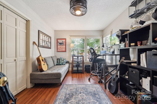 office space with a textured ceiling and wood finished floors