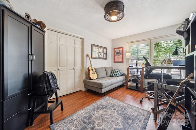 home office featuring a textured ceiling and wood finished floors