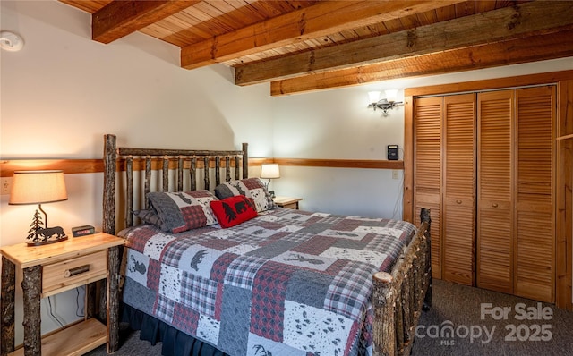 bedroom with wooden ceiling, carpet floors, a closet, and beam ceiling