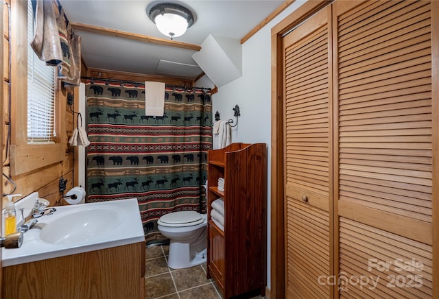 bathroom featuring toilet, a shower with curtain, a closet, tile patterned flooring, and vanity