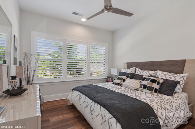 bedroom with baseboards, ceiling fan, wood finished floors, and visible vents