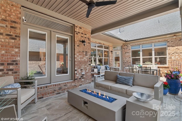 view of patio / terrace with french doors, an outdoor living space with a fire pit, and ceiling fan