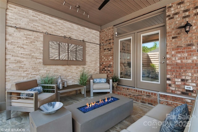view of patio / terrace featuring a fire pit and french doors