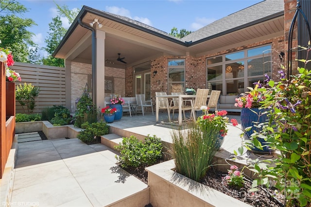 view of patio featuring ceiling fan and fence