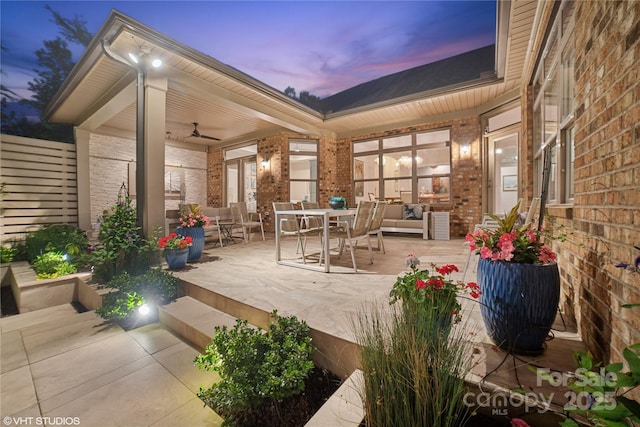 view of patio featuring a ceiling fan, outdoor dining area, and a deck