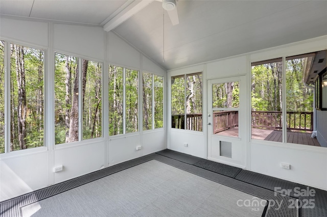 unfurnished sunroom featuring beamed ceiling and a ceiling fan