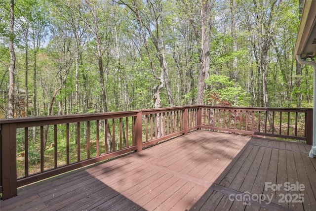 wooden deck featuring a wooded view