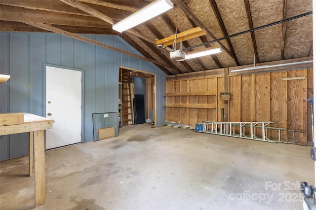 garage with a garage door opener and wood walls