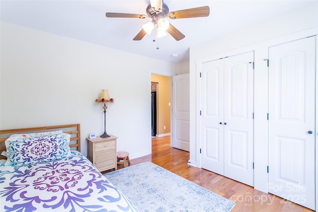 18 Benzington Way, Leicester, NC 28748 - bedroom with light wood finished floors, ceiling fan, and baseboards