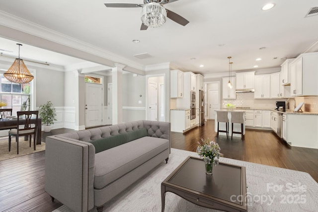 907 Ospre Ln, Fort Mill, SC 29708 - living area with crown molding, dark wood finished floors, ceiling fan, and recessed lighting