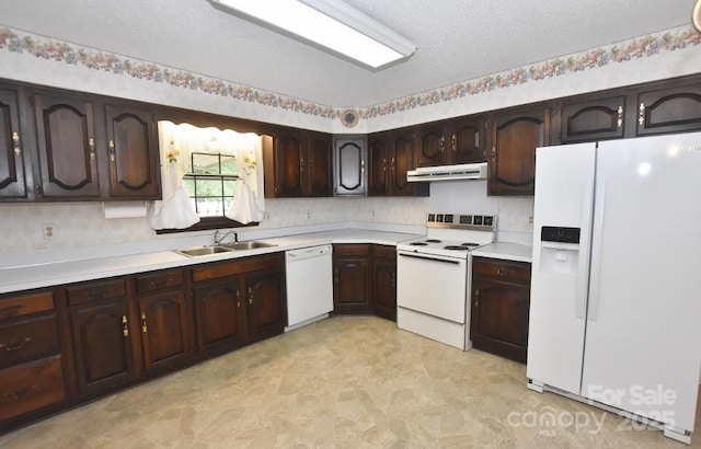 902 Church St NW, Valdese, NC 28690 - kitchen with a textured ceiling, a sink, light countertops, under cabinet range hood, and white appliances