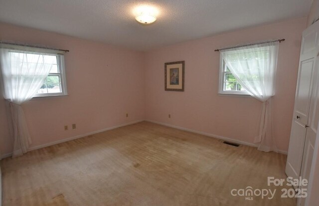 902 Church St NW, Valdese, NC 28690 - unfurnished room featuring light colored carpet, baseboards, and visible vents