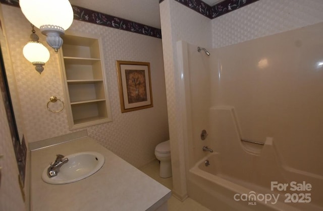 902 Church St NW, Valdese, NC 28690 - bathroom featuring vanity, toilet, wallpapered walls, and bathtub / shower combination