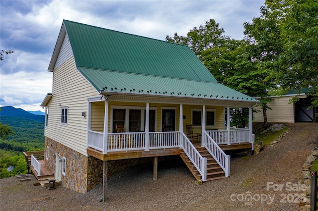 1053 Rich Hill Mountain Rd, Glade Valley, NC 28627 - view of front of property featuring stone siding, a porch, stairway, a mountain view, and metal roof