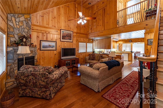 1053 Rich Hill Mountain Rd, Glade Valley, NC 28627 - living area featuring high vaulted ceiling, a stone fireplace, wood walls, and wood finished floors