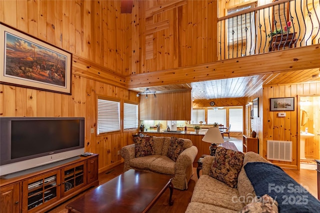 1053 Rich Hill Mountain Rd, Glade Valley, NC 28627 - living area featuring wood walls, wood finished floors, and visible vents