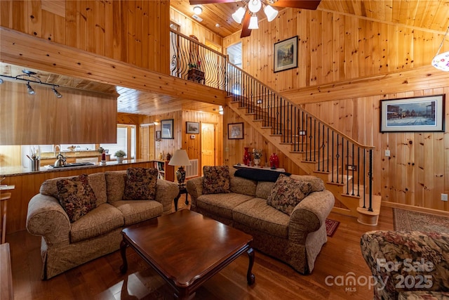 1053 Rich Hill Mountain Rd, Glade Valley, NC 28627 - living room featuring wooden walls, ceiling fan, wood finished floors, wood ceiling, and stairway