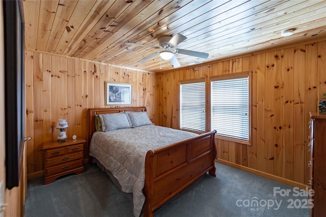 1053 Rich Hill Mountain Rd, Glade Valley, NC 28627 - carpeted bedroom featuring wooden ceiling, baseboards, wood walls, and ceiling fan