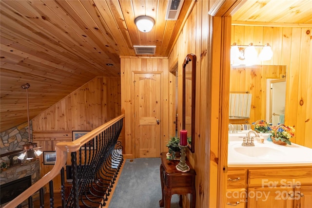 1053 Rich Hill Mountain Rd, Glade Valley, NC 28627 - hallway featuring a sink, wood ceiling, wooden walls, and carpet flooring