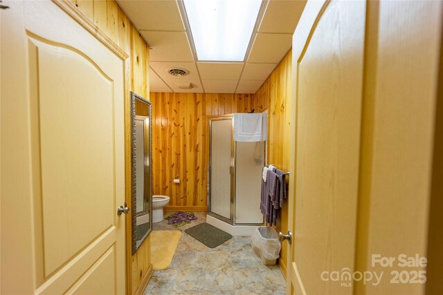 1053 Rich Hill Mountain Rd, Glade Valley, NC 28627 - full bathroom with visible vents, toilet, a drop ceiling, wooden walls, and a shower stall