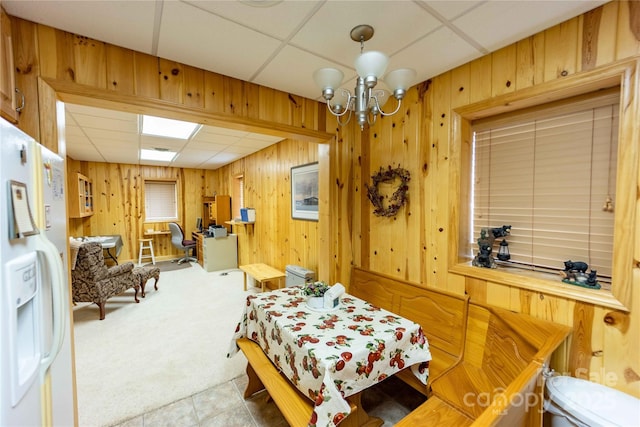 1053 Rich Hill Mountain Rd, Glade Valley, NC 28627 - bedroom with white refrigerator with ice dispenser, a chandelier, wooden walls, a drop ceiling, and carpet flooring