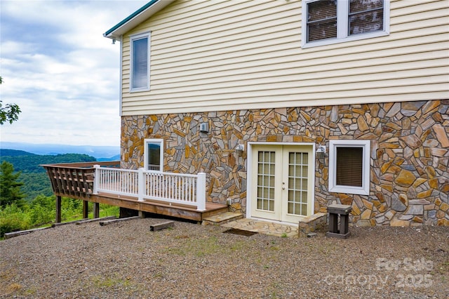 1053 Rich Hill Mountain Rd, Glade Valley, NC 28627 - view of exterior entry featuring french doors, a wooden deck, and stone siding