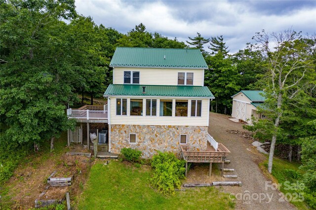 1053 Rich Hill Mountain Rd, Glade Valley, NC 28627 - back of property with an outbuilding, a wooden deck, metal roof, and stone siding