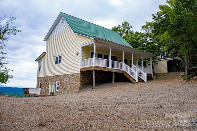 1053 Rich Hill Mountain Rd, Glade Valley, NC 28627 - back of property featuring a porch, driveway, stone siding, and metal roof