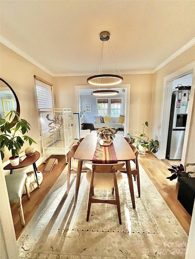 dining room featuring ornamental molding and wood finished floors
