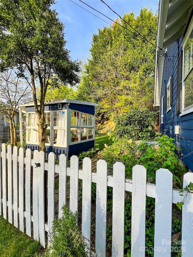 view of yard with an outbuilding and fence