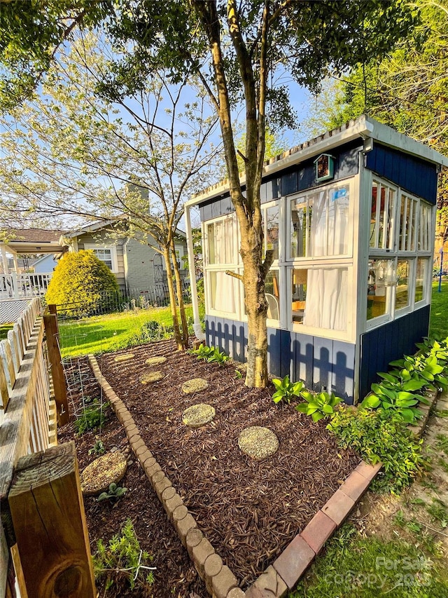 exterior space with fence and an outdoor structure